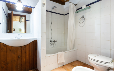 This bedroom has a bathroom with half bath tub